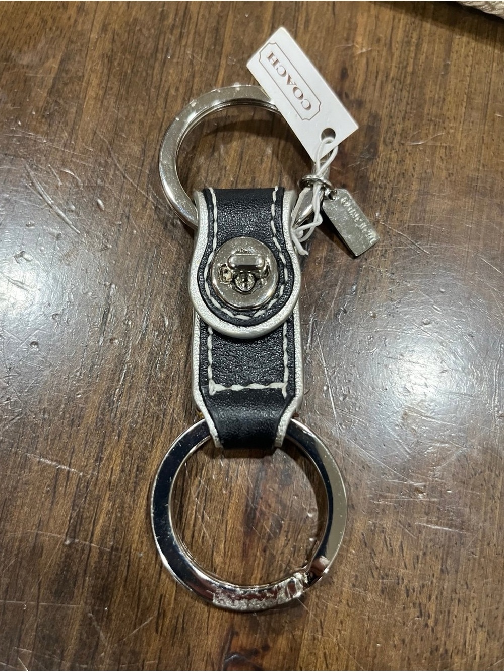 Coach black leather valet keychain.